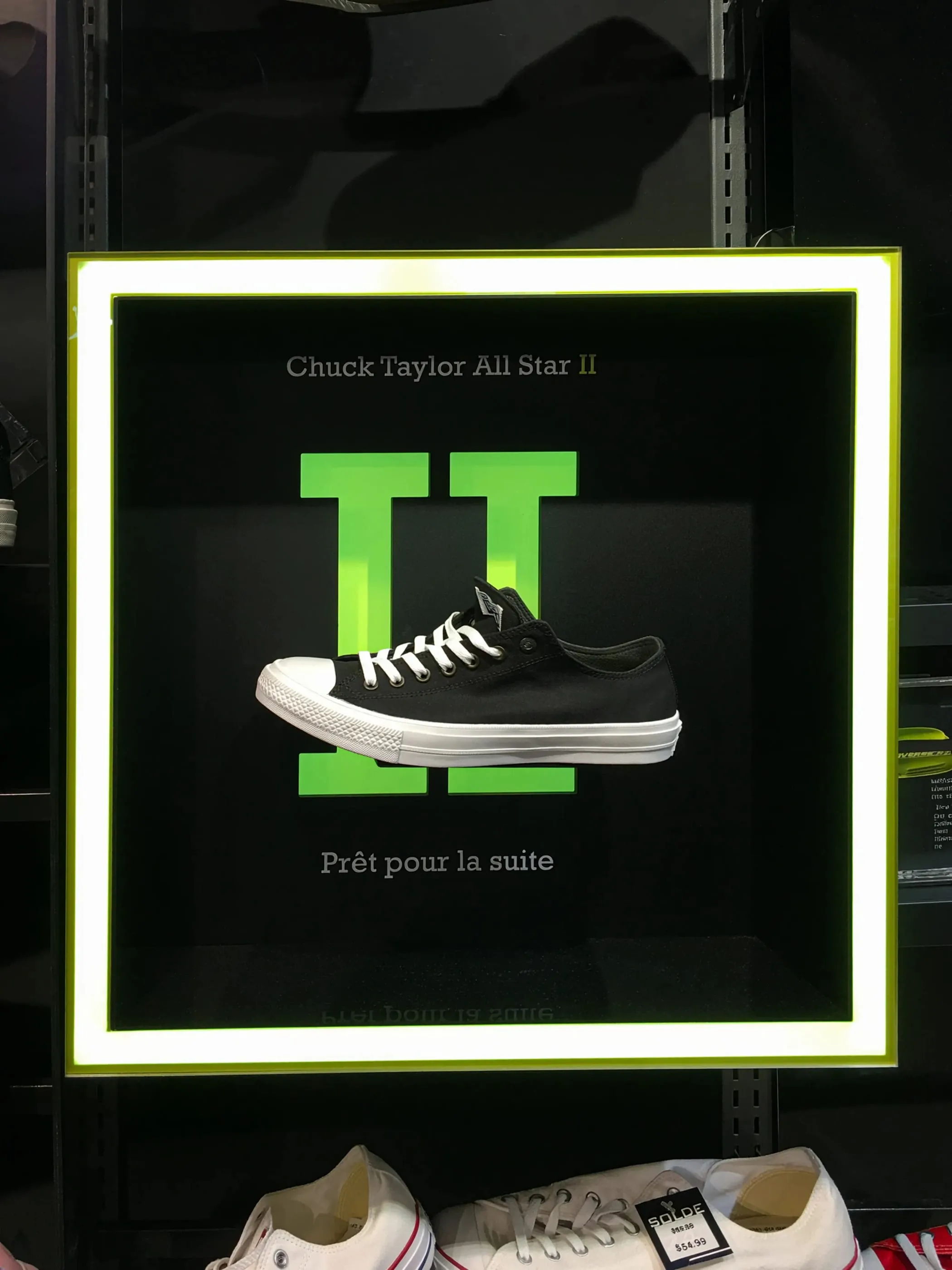 Illuminated Converse Chuck Taylor display with a sneaker framed in a lit green border
