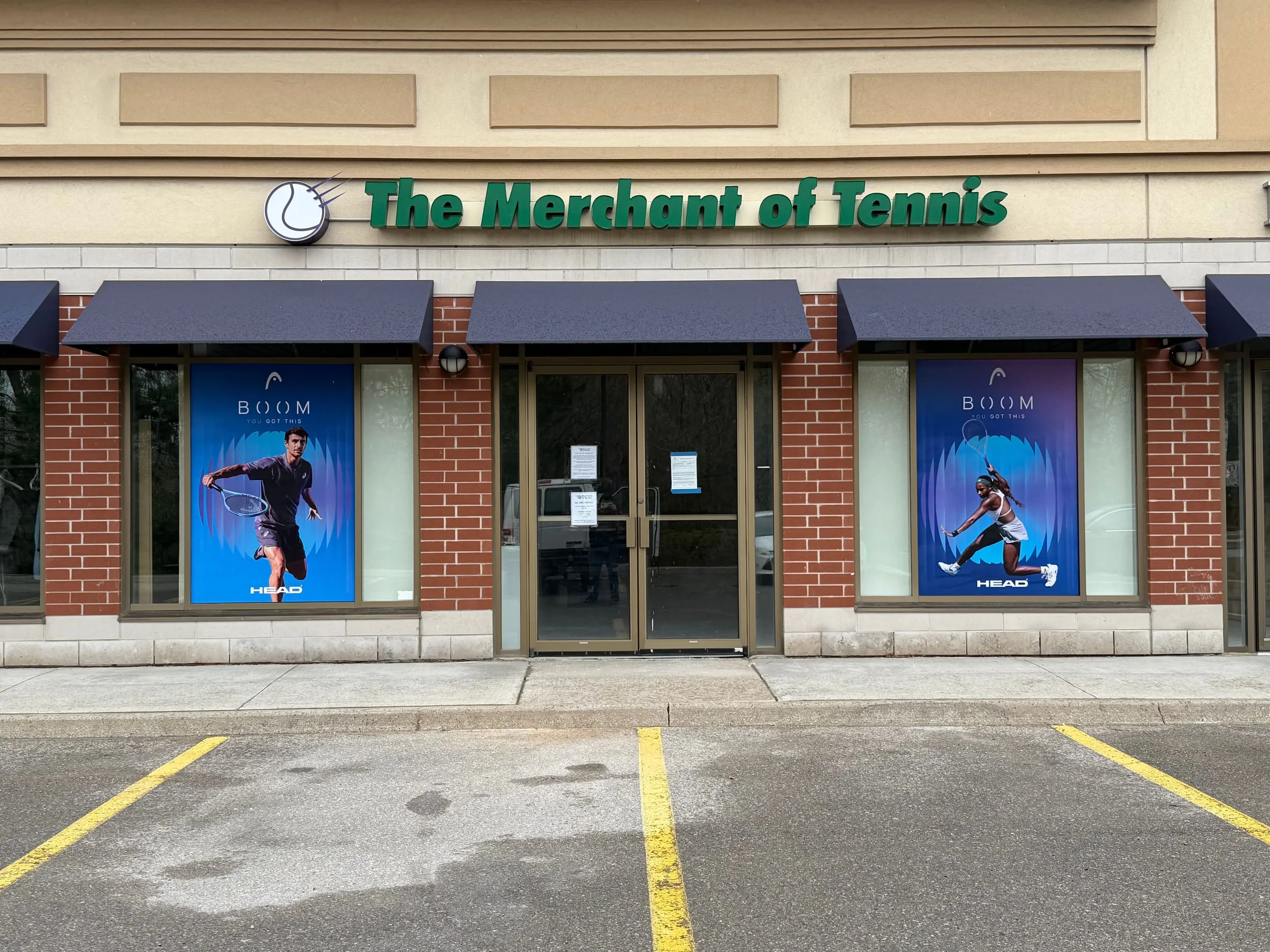Tennis shop storefront with printed posters of tennis players in the windows
