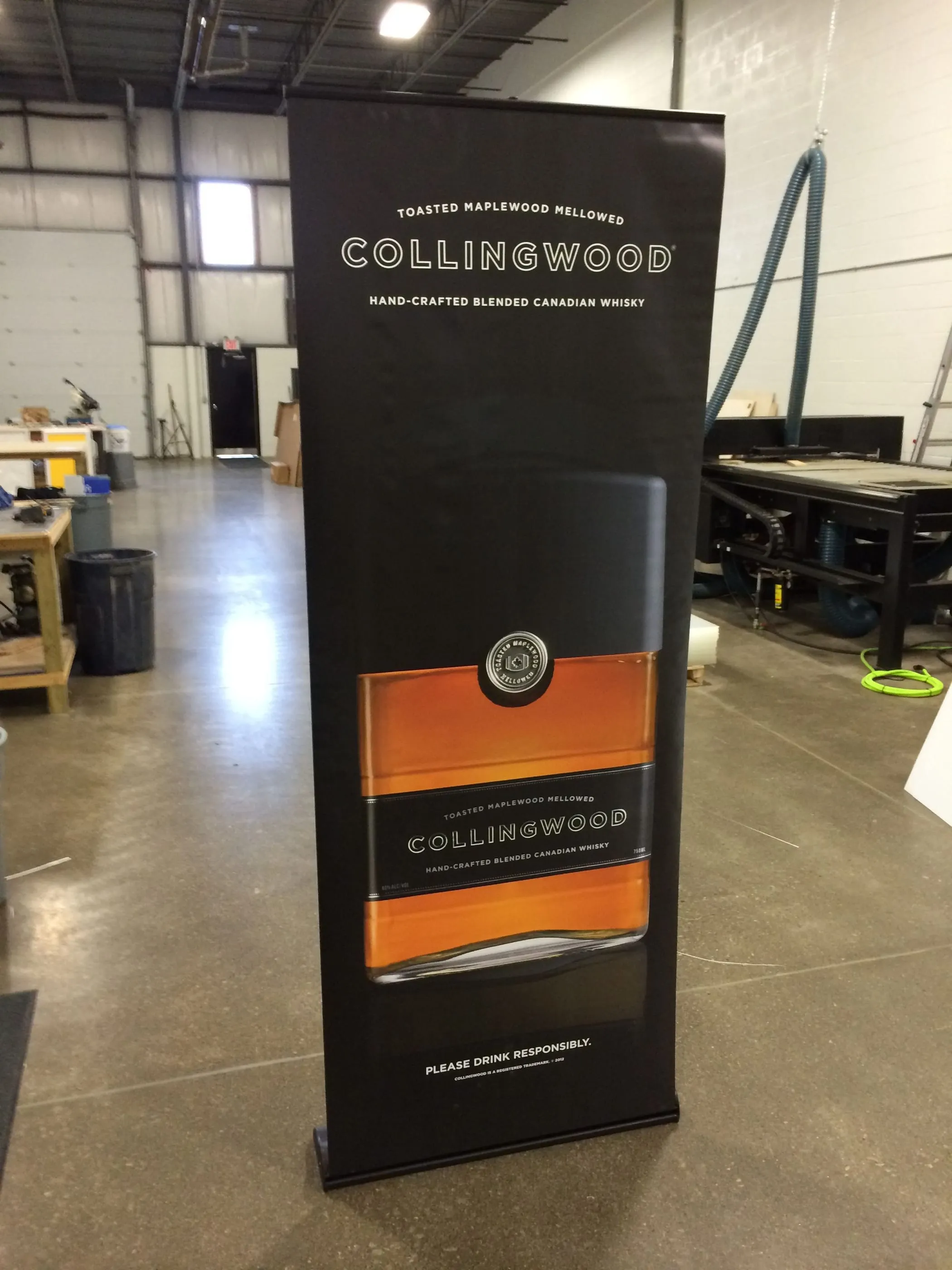 Retractable banner stand for Collingwood Canadian whisky, in the shop
